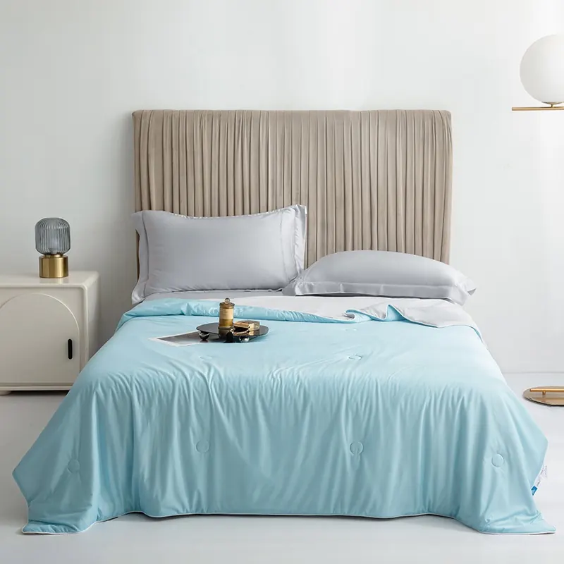 The Snoozeloom cooling doona in Sky Blue on a made bed